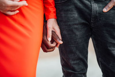 Midsection of man holding hands