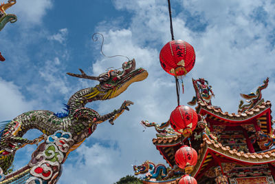 Low angle view of lanterns hanging against sky