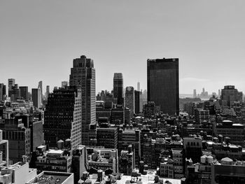 Modern buildings in city against clear sky