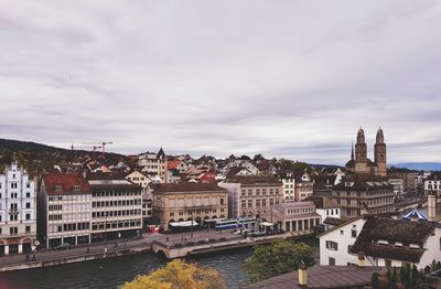 View of cityscape against cloudy sky