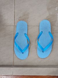 High angle view pair of slippers or flip-flop on tiled floor