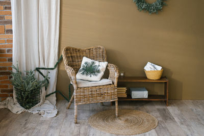 Wicker armchair in living room with christmas scandinavian minimalist decor in a country house