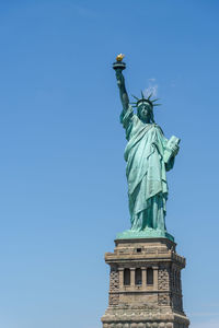 Low angle view of statue against blue sky