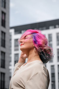 Portrait of beautiful woman against blurred background