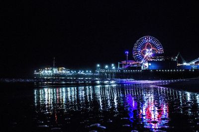 Illuminated ferris wheel at night