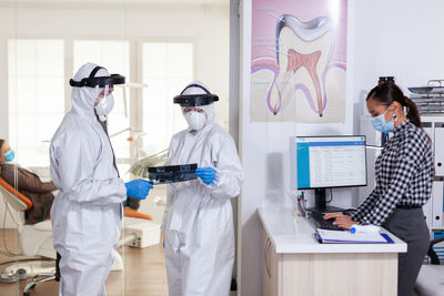 Female friends standing in laboratory