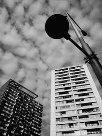 Low angle view of building against cloudy sky