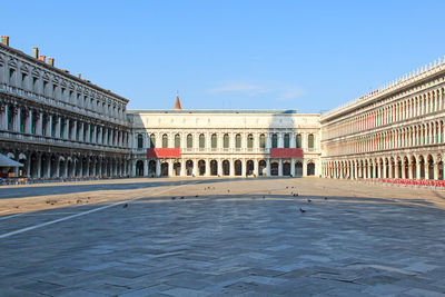 Buildings in front of old town against clear blue sky