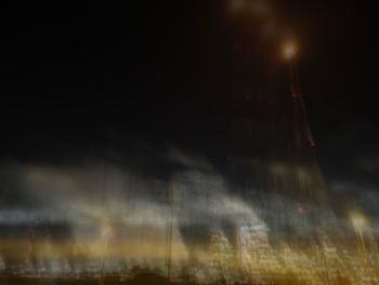 Blurred motion of wet window at night