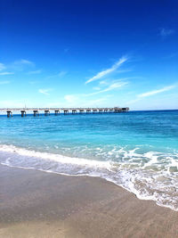 Scenic view of sea against blue sky