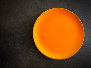 Directly above shot of orange slice against black background