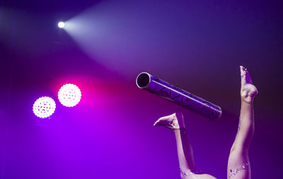 Low section of woman performing with pipe on stage