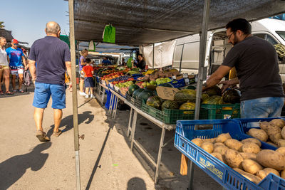 Rear view of people at market stall