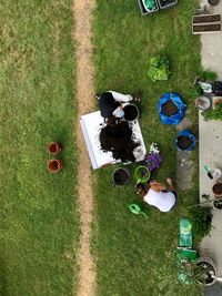 High angle view of woman sitting on field