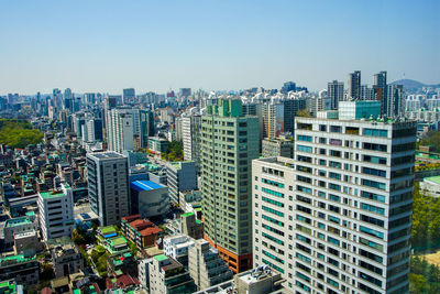 Modern buildings in city against clear sky