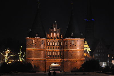 Holstentor against sky in city at night