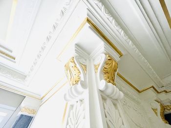 Low angle view of statue building wall interior design background with gold 