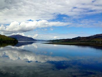 Scenic view of lake against cloudy sky