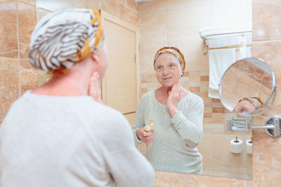 Elderly woman taking care of her face