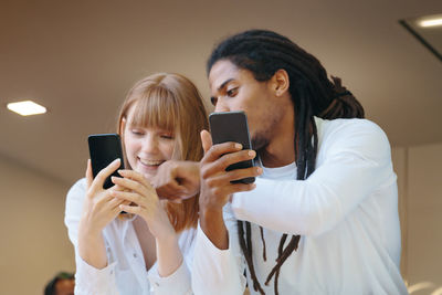 Portrait of young woman using mobile phone