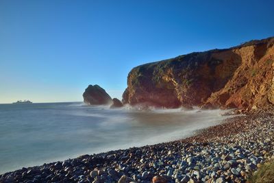 Scenic view of sea against clear blue sky