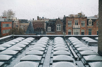 Snow covered buildings against sky