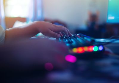 Close-up of hands playing guitar on table