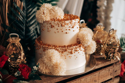 Elegant two-layer round cake on wooden table. rustic style decoration.