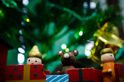 A collection on miniature wooden toys under a small christmas tree to celebrate the yuletide season.