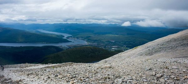 Scenic view of mountains against cloudy sky