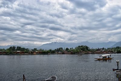 Boats moored in lake against sky