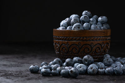 Close-up of fruits on table against black background