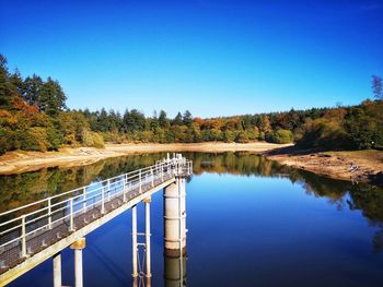 Scenic view of bridge against clear blue sky