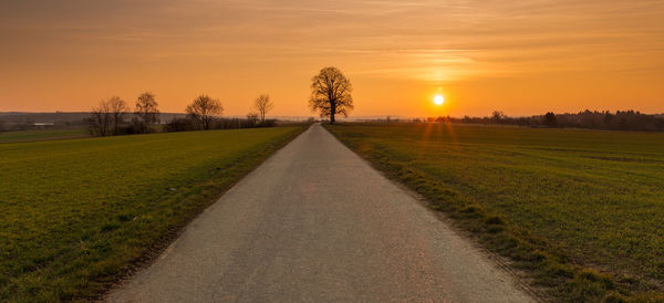 Scenic view of field against sky during sunset