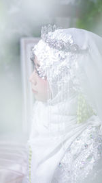 Close-up of woman wearing white dress