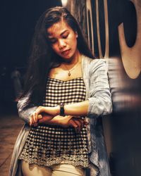 Young woman looking away while sitting in hair