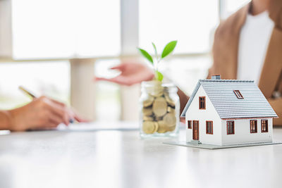 Midsection of woman holding toy on table