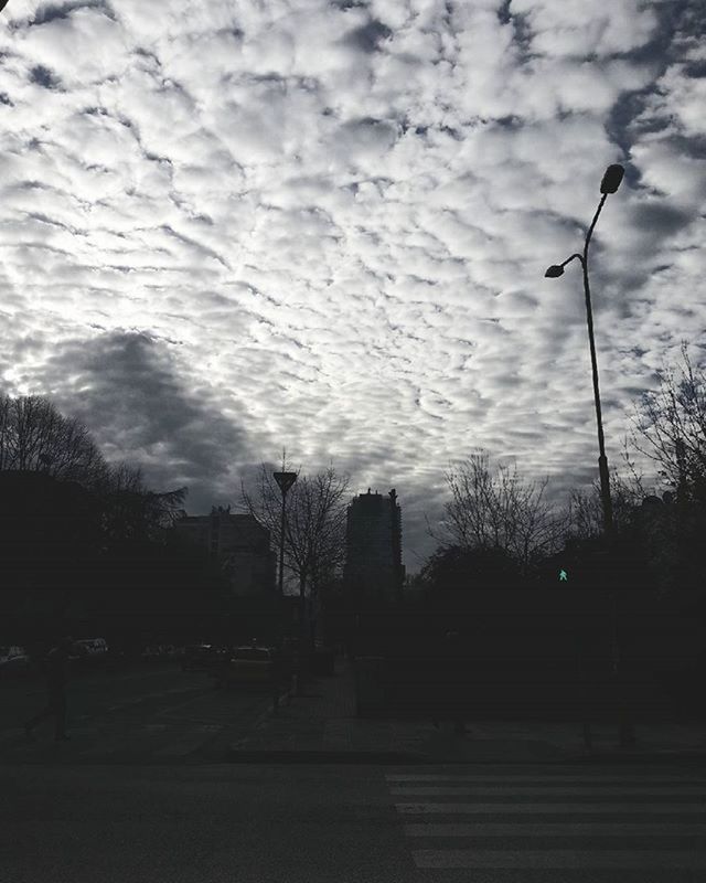 sky, street light, cloud - sky, silhouette, cloudy, tree, sunset, cloud, road, street, transportation, dusk, lighting equipment, nature, weather, outdoors, the way forward, overcast, built structure, tranquility