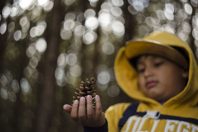 Portrait of boy holding hat