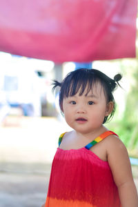 Portrait of cute girl standing against sky