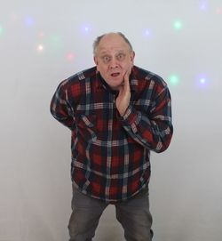 Portrait of man standing against illuminated background
