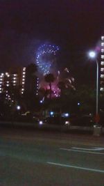 Firework display over city at night