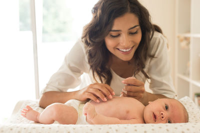 Mother playing with son at home