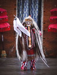 Full length of woman standing in mask