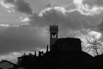 Low angle view of building against cloudy sky