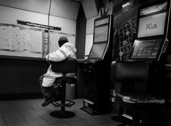 Rear view of man standing on seat