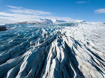 Aerial view of snowcapped mountains against sky