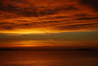 Scenic view of sea against orange sky