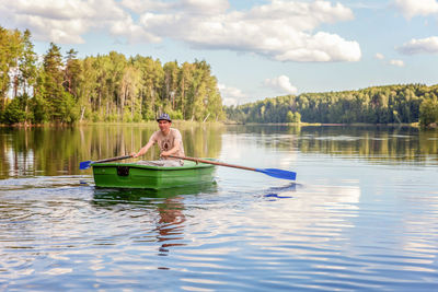 Man kayaking in lake