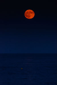 Scenic view of sea against clear sky at night